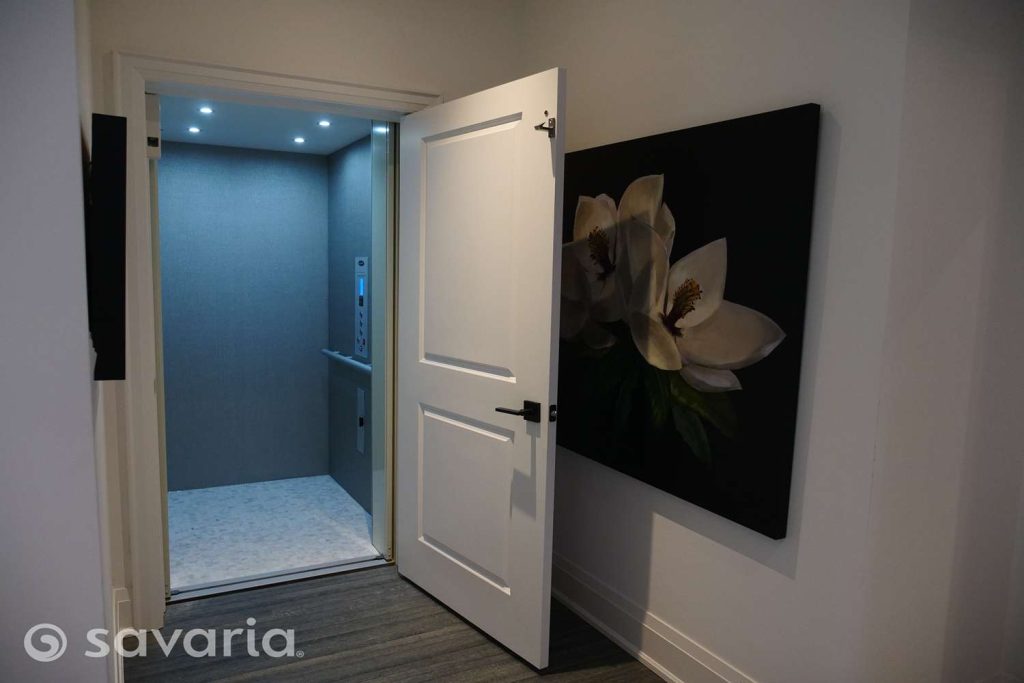 Savaria Infinity home elevator with an anodized clear finish and glass enclosure, installed in a modern home.