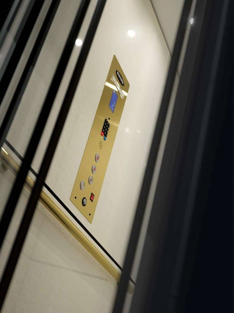 Savaria Zenith Home Elevator Interior With Gold Color Control Panel and Handrail.