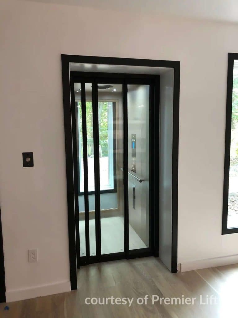 Savaria Eclipse Residential Elevator with Black Framed Glass Doors in a modern interior.