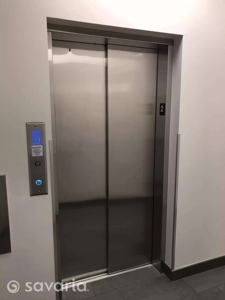 Savaria Orion 17 Commercial Closed Elevator with Stainless Steel Door On The Second Floor.