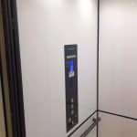 Interior of a Modern Savaria Elevator with Sleek White Walls With Control panel and handrail.