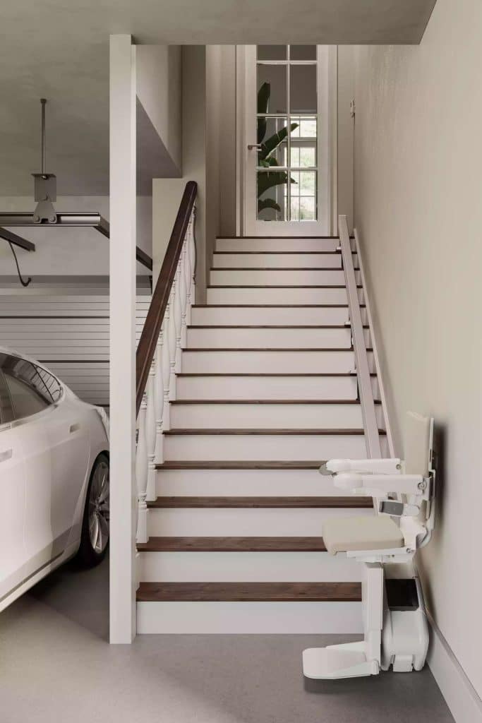 Staircase in a garage with Handicare 1100 straight stairlift and a partially visible white car.