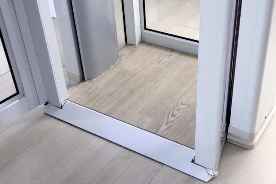 Accessible Savaria Luma elevator with flat threshold and wood-textured floor.